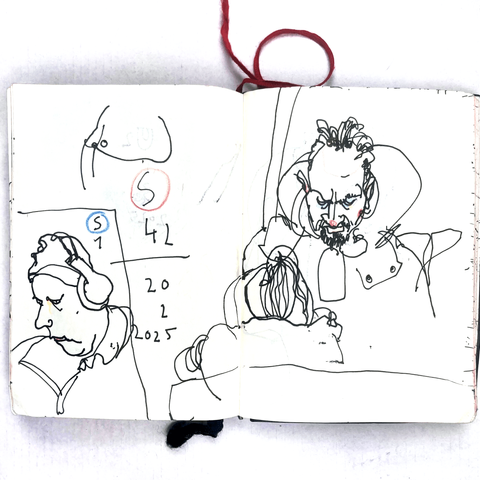 photo of a small sketchbook with a pen drawing from a berlin u-train
