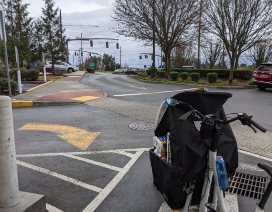 Cargo bike loaded up, mountain hiding behind clouds, traffic Engineer nowhere to be found, stroad really stroady