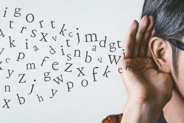 Man holding his hand up to his ear while an unintelligible stream of Latin characters enters it