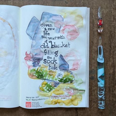 Photo of a haiku illustrated with ink in an open notebook next to two glass dip pens, one of which is just a tip. Portrait orientation depicting a pair of warm, colourful socks with a patchwork feel.
"given a new life
the warmth of an old blanket
filling the sock hole"
- Poetry and art by Maiji/Mary Huang, humangray.com