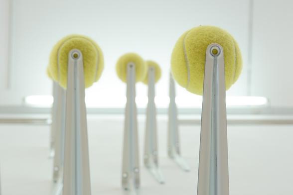 a sculpture made from yellow tennis balls