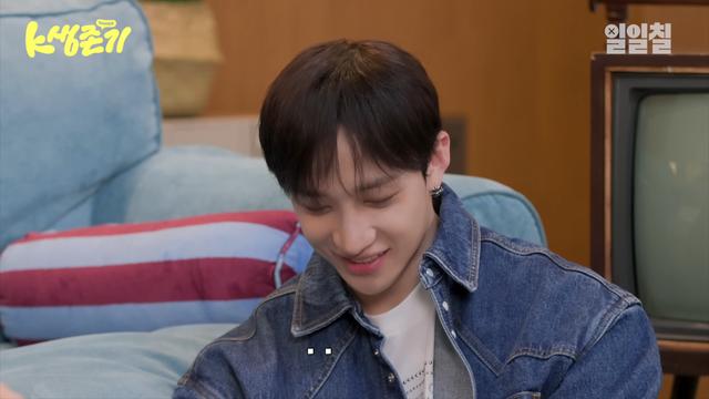 Bang Chan looks down and smiles a little bashfully