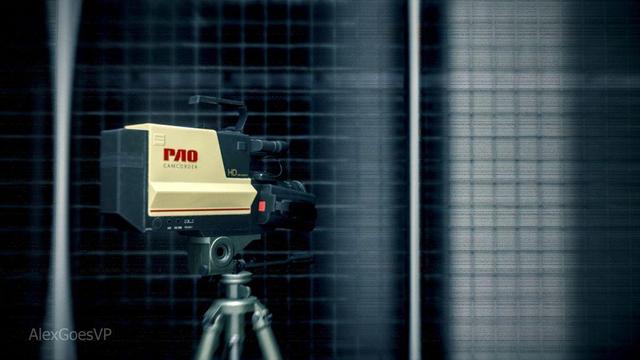 A PAO Camcoder standing on a tripod in front of a window with a grid pattern and a old VHS effect.