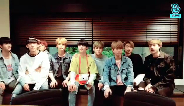 Stray Kids members sitting on a bench at the start of a livestream. Changbin is on Seungmin's lap, with Seungmin's hands on his waist.