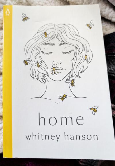 Book cover of Home by Whitney Hanson. Features a minimalistic portrait drawing of a girl with short hair surrounded by bumble bees.