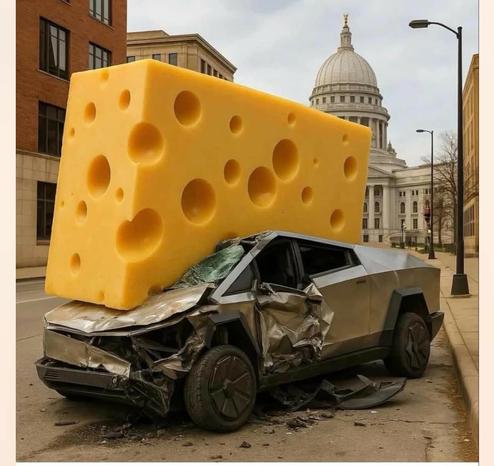 A Tesla Cybertruck crushed under a giant block of cheddar cheese