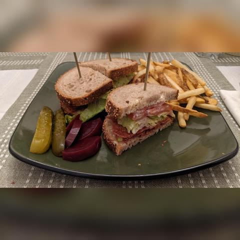 BLT sandwich with french fries, and pickled cucumber and beets
