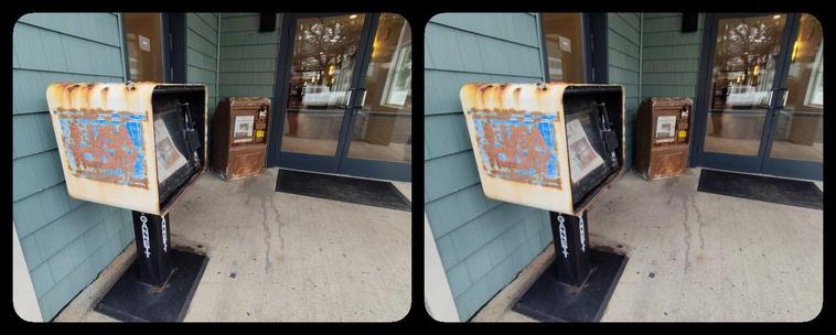 A rusty USA Today newspaper vending machine.