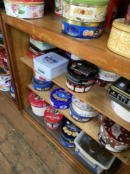 Lower shelves had lots of chocolate and biscuit tins.