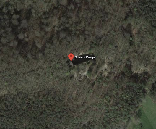 A Google Maps view of a forest with a rectangular black hole in the middle.