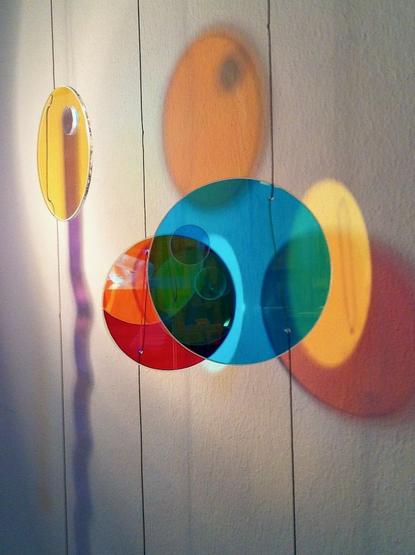 a wind chime made out of colored glass elements