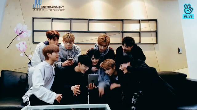 skz members during a livestream. Lee Know is behind Hyunjin, and is in the middle of attempting to get his hand inside Hyunjin's hoodie