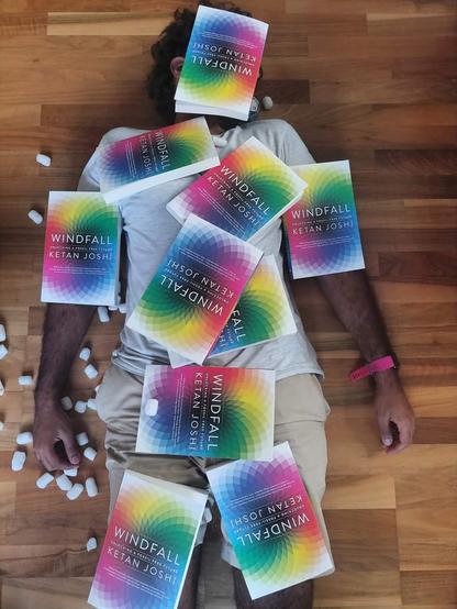 me lying on the ground covered in copies of my book