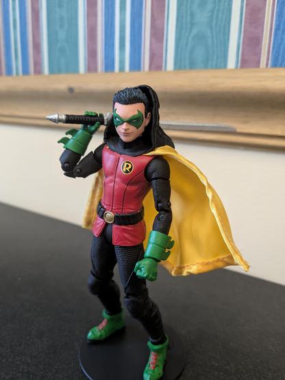 McFarlane Damian Wayne as Robin figure holding a sword over his shoulder in a relaxed pose