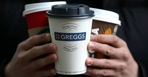 Hands holding coffee cups from Costa, Pret and Greggs.
