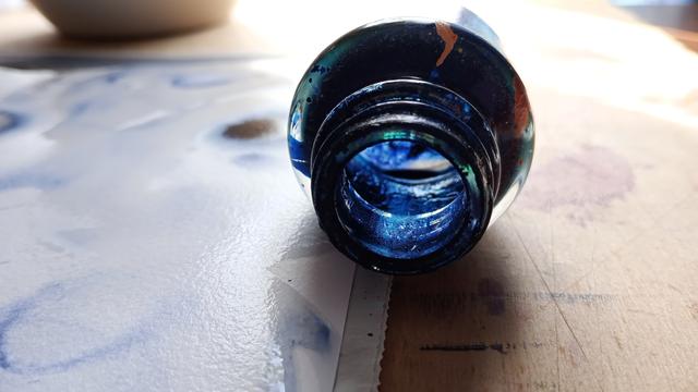 Empty ink bottle on its side