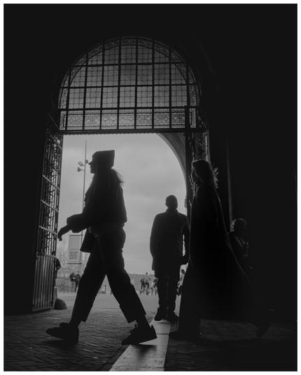 People walking under and arch