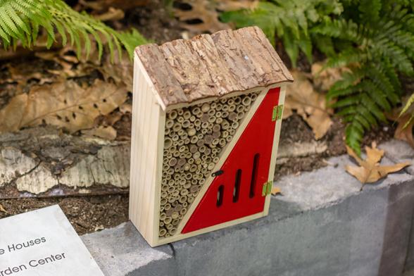 Insect hotel with sections of bamboo and decorative roof with a 1/2" overhang.