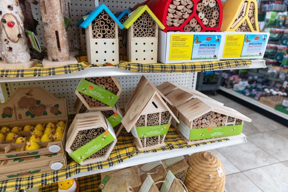 Display of insect hotels at a store. Most are filled with bamboo.