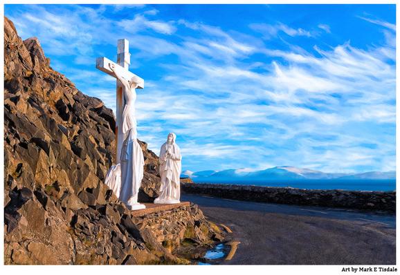 Color photograph with a view from the Slea Head Road on the Irish Coast. On one side is a profile view of a crucifixion scene on the cliffs on one side of the road. The road curves out of view and in the background are blue skies with thin traces of clouds.