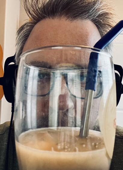 Selfie of me with a glass of iced coffee in front of my face.