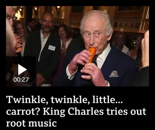 King Charles in a suit is playing a carrot like a flute.