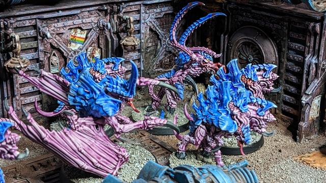 A group of Tyranids aliens painted in blue and purple. Here you can see parts of the group.