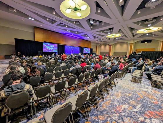 A large crowd in a conference ballroom
