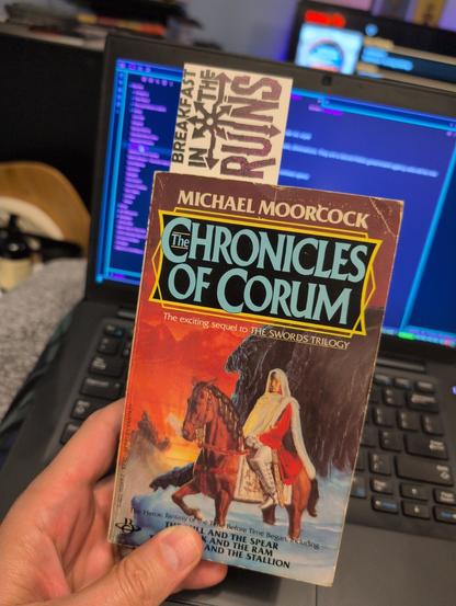 Hand holding the Chronicles of Corum