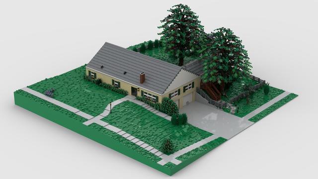 A photo-realistic render of a Lego model. The model is of a suburban home, yard and all, built to minifigure scale. The front yard is nearly all grass, with a few flowers and hedges here and there. The back yard is fenced-in and has two large trees that are taller than the house. A chimney can be seen in the front of the house right next to the front door. A garage is visible, under the ground floor of the house. The windows have green shutters on them and the brick is a light tan color.