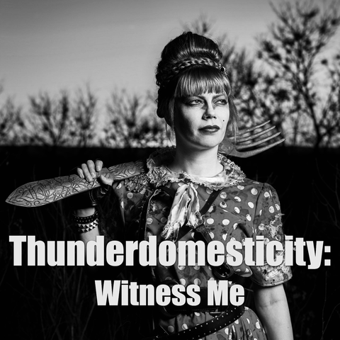 “Thunderdomesticity: Witness Me” is written in bold gray text in front of a monochromatic photograph of a dystopian dame, dressed in distressed polkadots, who is armed with a giant wooden fork.