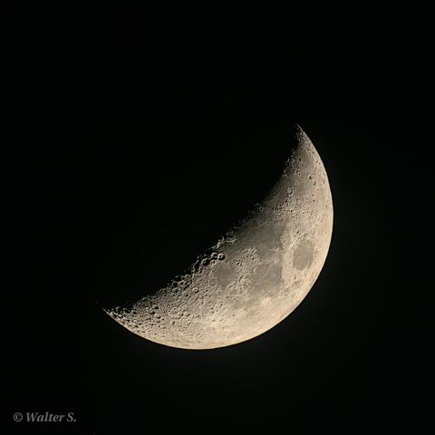 A waxing moon at ca. 38% illumination in a black sky
