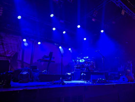 Empty stage, taken from front left. Dark blue lights illuminating the scene