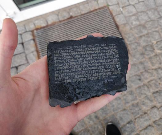 me holing a rock with a ssh private key written on it