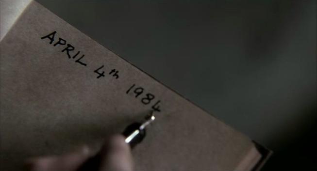 Tidy block letters on the first page of a book. A man's hand is writing with an ink pen. It says April 4th, 1984