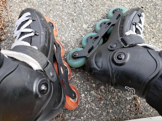 My black FR boots with 4x80mm wheels. The left set are orange and the right set are blue. They're luminous wheels that light up when they spin, though they're hard to see in daylight.