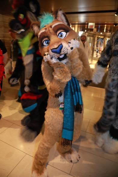Lioness fursuiter touching face with paws