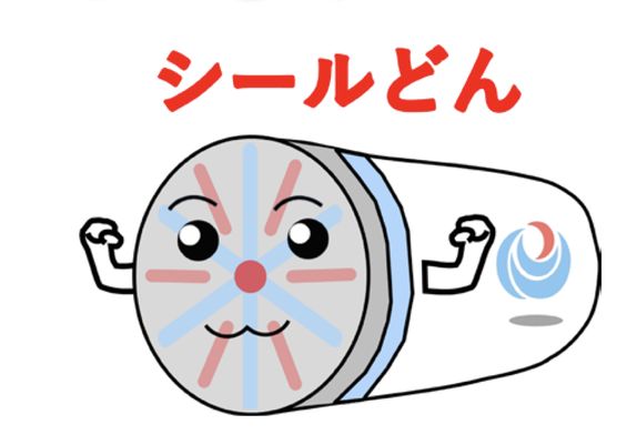 A japanese character, apparently drawn in MS paint, of a tunnel boring machine. He is shaped like a cylinder, with hands sticking out the sides. On the boring end, there are the scores for the bores and it has a face with an omega-style mouth, and a red nose in the middle. On the side is the logo for the Japanese Ministry of Land, Infrastructure, Transport and Tourism