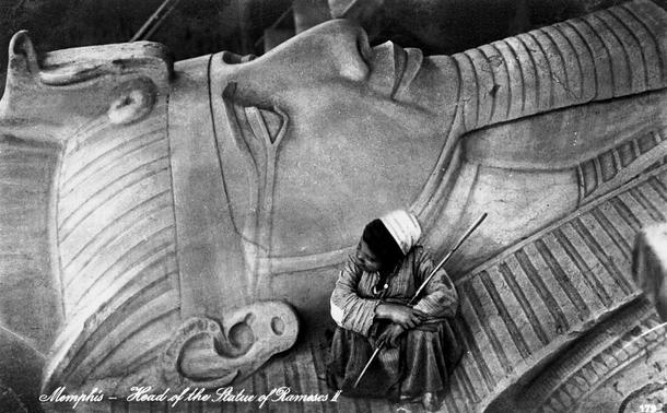 Head of the statue of Ramses II, lying at Memphis, with a shepherd boy sitting on it