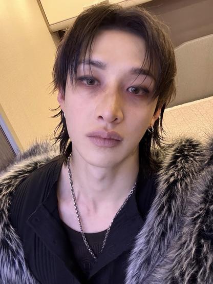 Selfie of Bang Chan in his 2nd look from the Escape video. His pendant is tucked inside of his shirt