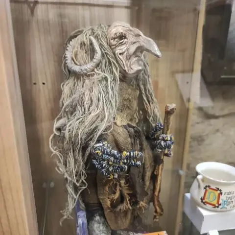 Frau Perchta  - a proud and terrifying mythical witch doll  with horns and long, beak-like nose proudly standing on a display in The Museum of Magic, Fortune-telling & Witchcraft in Edinburgh, Scotland.
