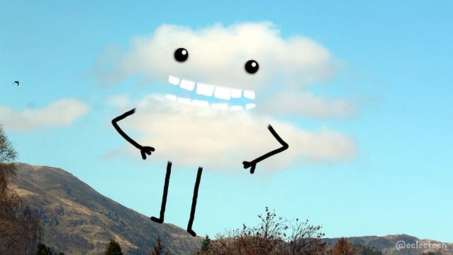 A photo of a cloud above a mountainside against a blue sky. I have drawn on it so it is standing on the hillside, with arms folded in front, a toothy grin and eyes.
