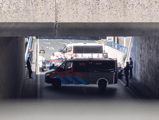 Two police vans with scientists in between