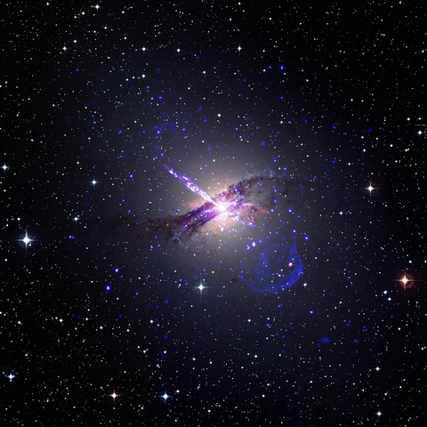 From source link in toot: In this composite image, a supermassive black hole at the center of the Centaurus A galaxy shoots an enormous jet of particles into a star-packed sky. Here, Centaurus A resembles an inky purple cloud sitting atop a translucent red cloud. At the heart of the combined cloud structure is the black hole, a brilliant white dot that lights the clouds from within. The jet emerges from this dot, a speckled white and purple beam shooting toward our upper left. Surrounding the entire galaxy is a faint translucent blue bubble shape, which is most pronounced at our lower right. This bubble was created by the jets from the black hole. Both the jets and the bubble are detected by Chandra.