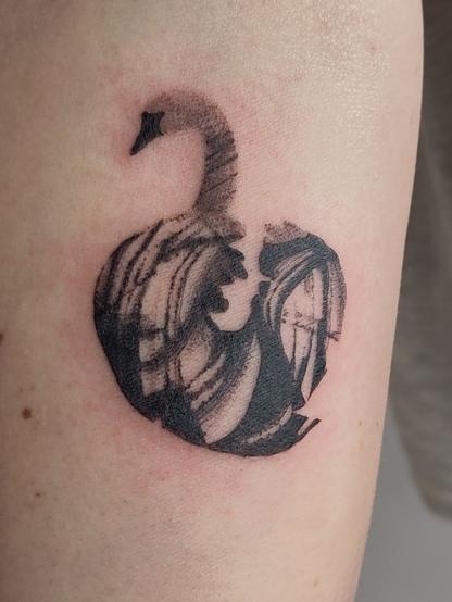 Swan tattoo on a lower arm
