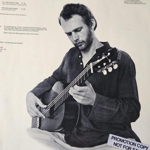 Photo from back cover features SM playing a guitar.