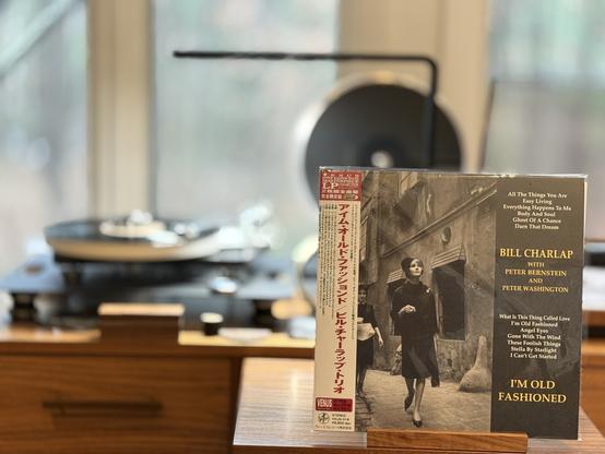 Bill Charlap Trio - I’m Old Fashioned LP cover.

A black and white picture of a woman in a coat walking down an old street. The album info is in a black bar on the right, and there’s an OBI on the left.

The black LP plays on a Rega NAIA turntable to the left.
