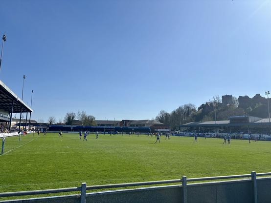 A sunny view over the rugby pitch with gorgeous blue sky and Newcastle castle just visible on the hill