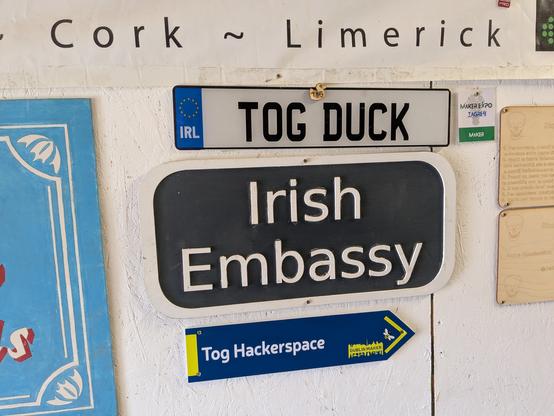 Signs on the wall at TOG hackspace 

Irish numberplate with "TOG DUCK"
Cast plate with" Irish Embassy"
Other sign with "Tog Hackerspace" and an arrow to the right