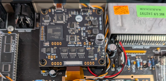 Inside of a modern Commodore 64 system, that where the RF Modulator is, there's a HD-64 module with a ribbon cable going towards the VIC-2 chip, and a couple of pins soldered for power and ground to the expansion port.